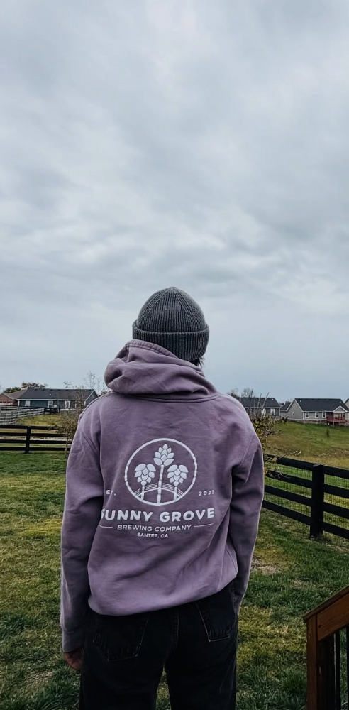 Person wearing a Sunny Grove hoodie standing in a field Title: Sunny Grove Hoodie