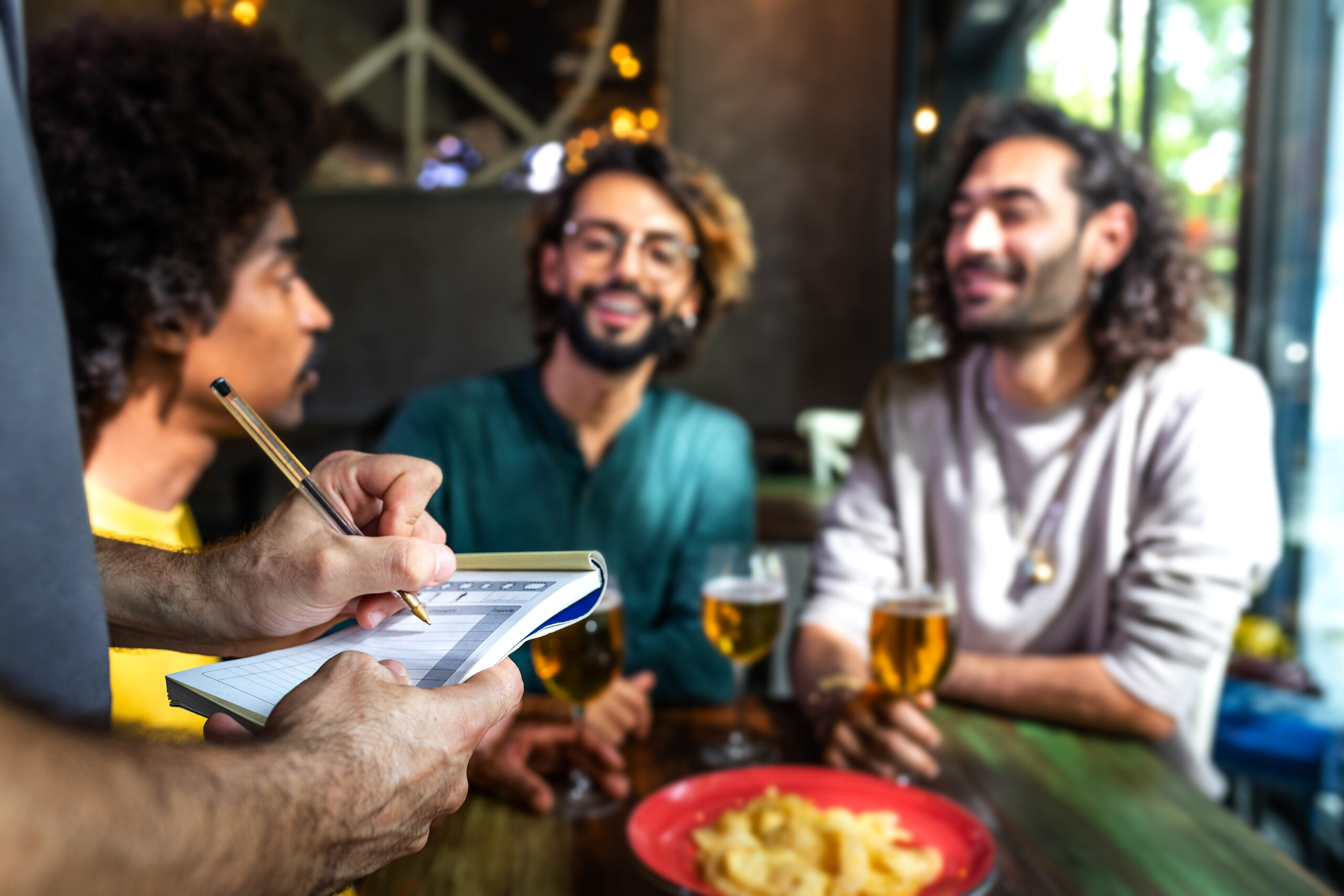 Stock photo of friends ordering beer at a bar